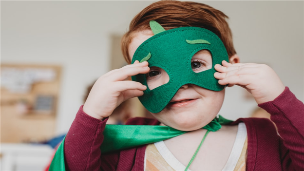 boy holding green mask